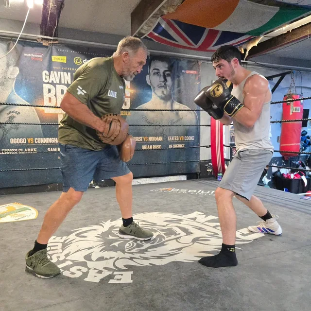 Louie working on the pads with his coach in the gym